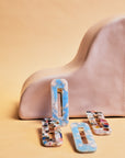Hair Barrettes -- InStyler-Lifestyle photo of 2 multi-colored and 2 blue and white barrettes.