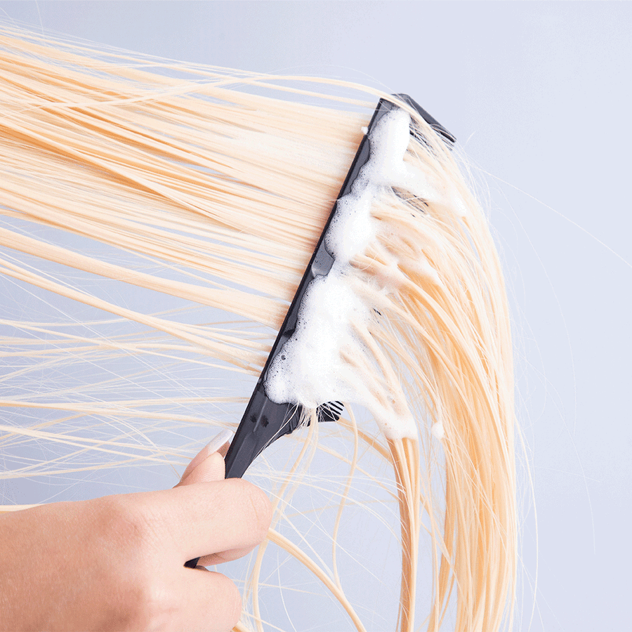 Comb being pulled through blonde hair using PROTECT Foam Heat Protectant-InStyler