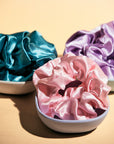 Satin Scrunchie Set -- InStyler-Close up of three scrunchies in pink, turquoise and lavender