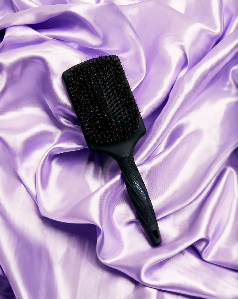 Smoothing Paddle Brush -- InStyler-lifestyle photo of brush on purple silk fabric