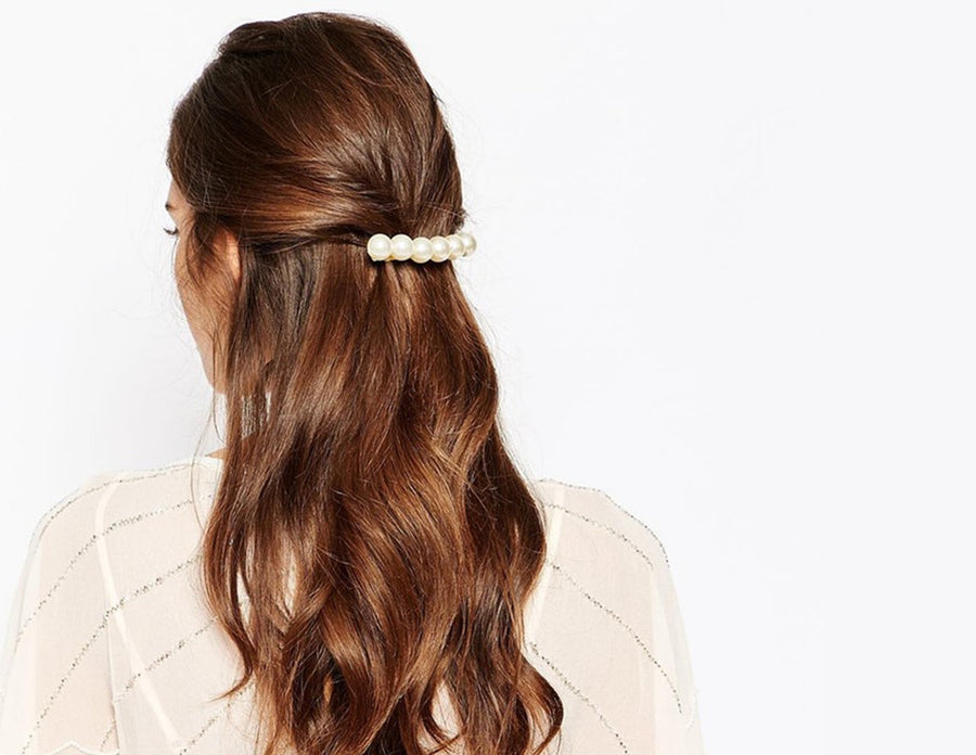 pretty flowing long curled hair pulled back in barrett