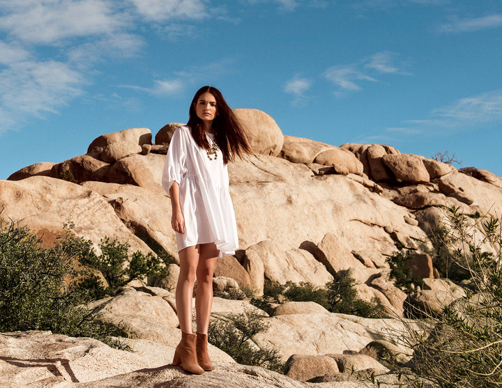 Girl standing on rocks in the dessert