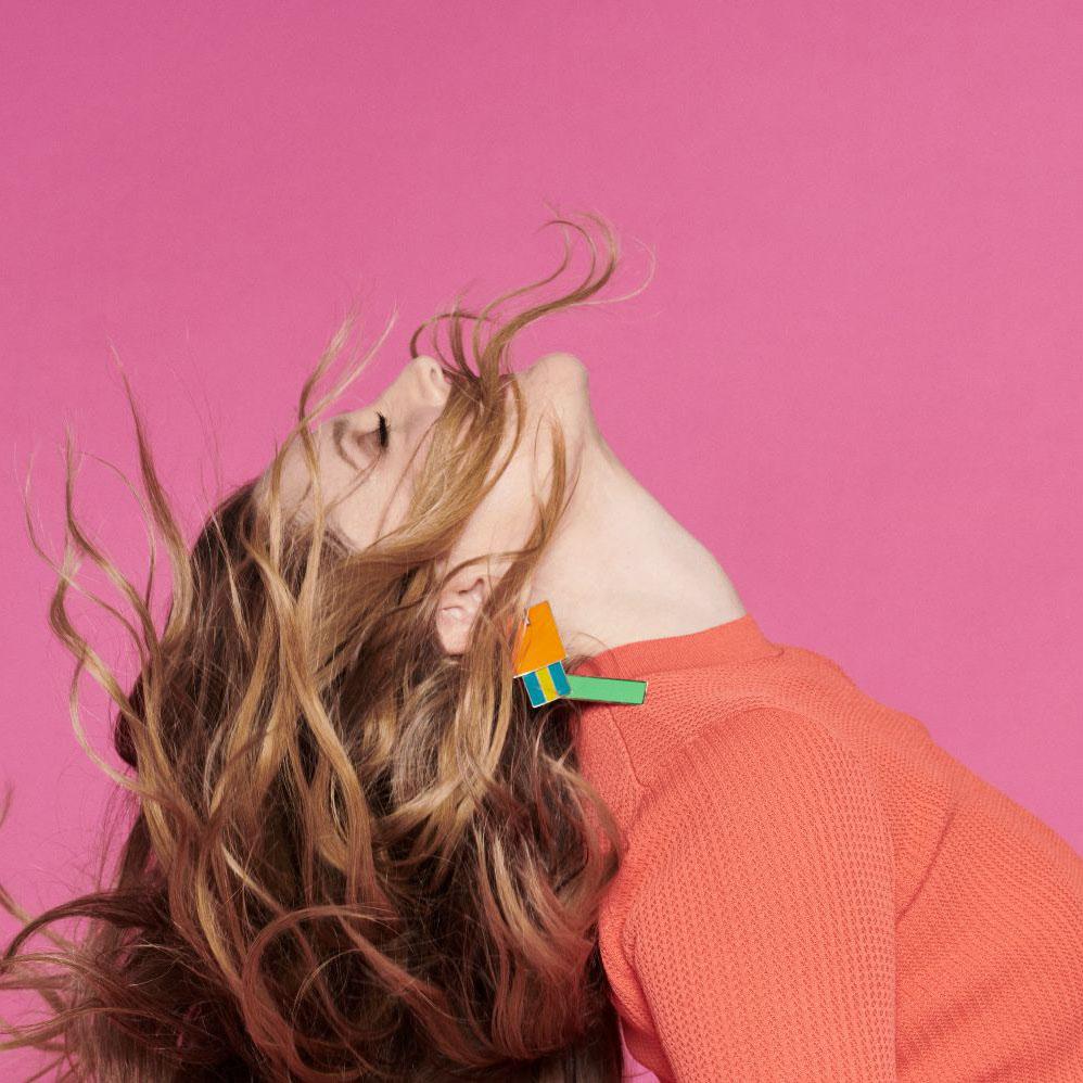 Profile of Drew Berrymore with her hair flying up in her face