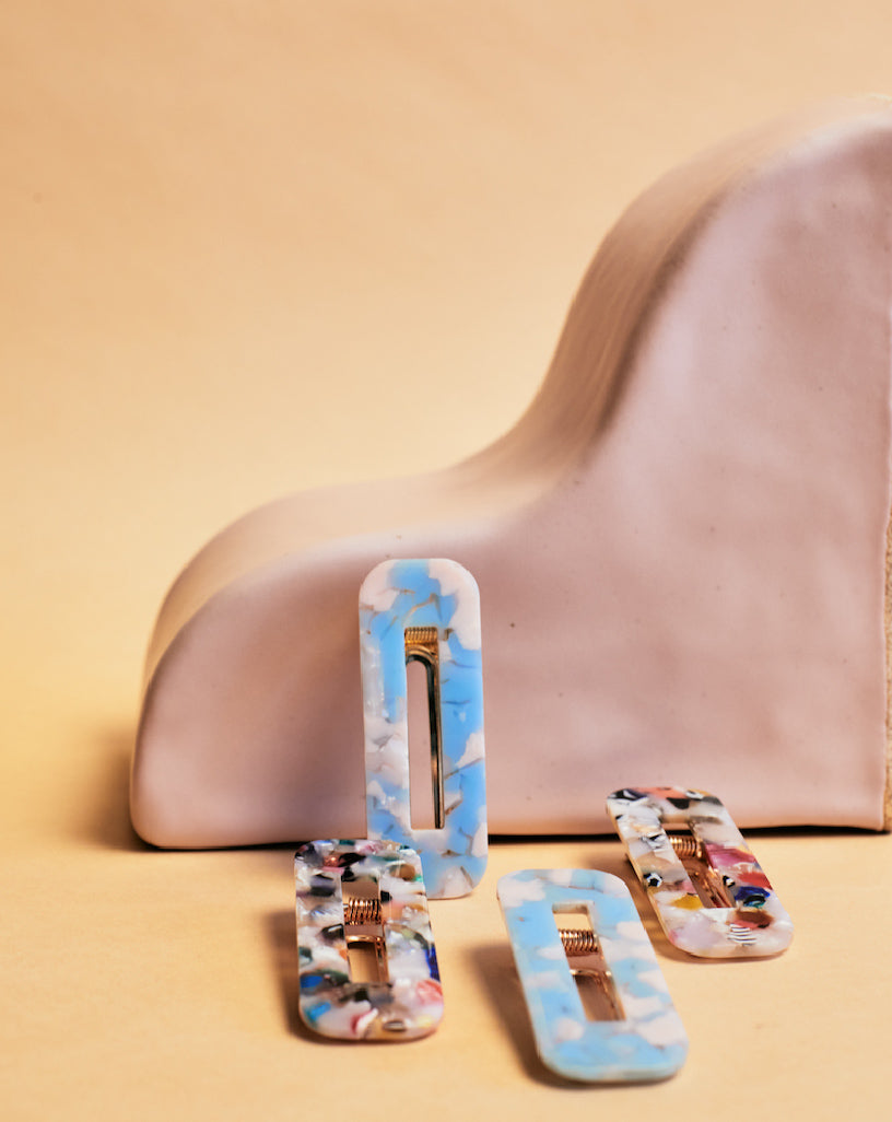 Hair Barrettes -- InStyler-Lifestyle photo of 2 multi-colored and 2 blue and white barrettes.