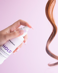 Photo of long brown hair being sprayed with HOLD Volumizing Hair Spray-InStyler