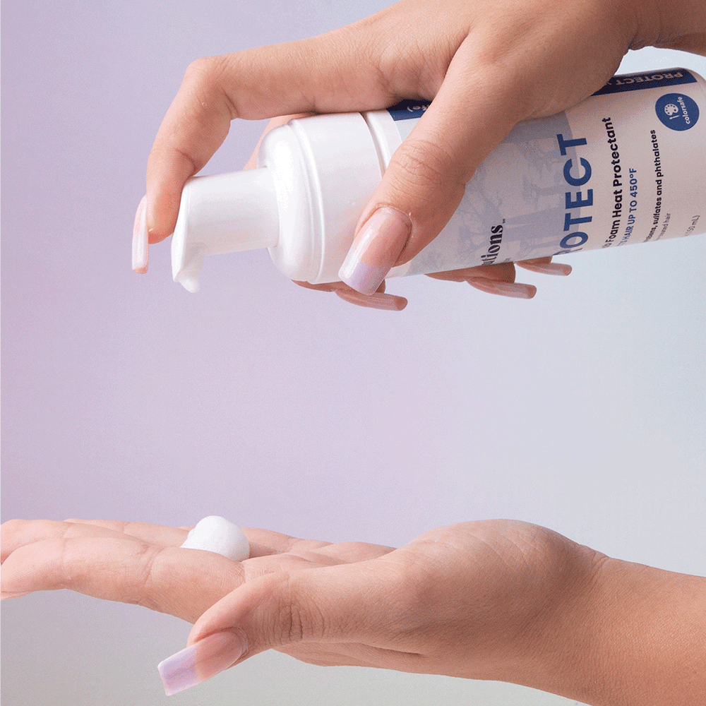 Photo of model squirting bottle of PROTECT Foam Heat Protectant into hand-InStyler